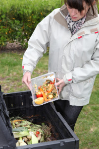 Woman making compost from old vegetables